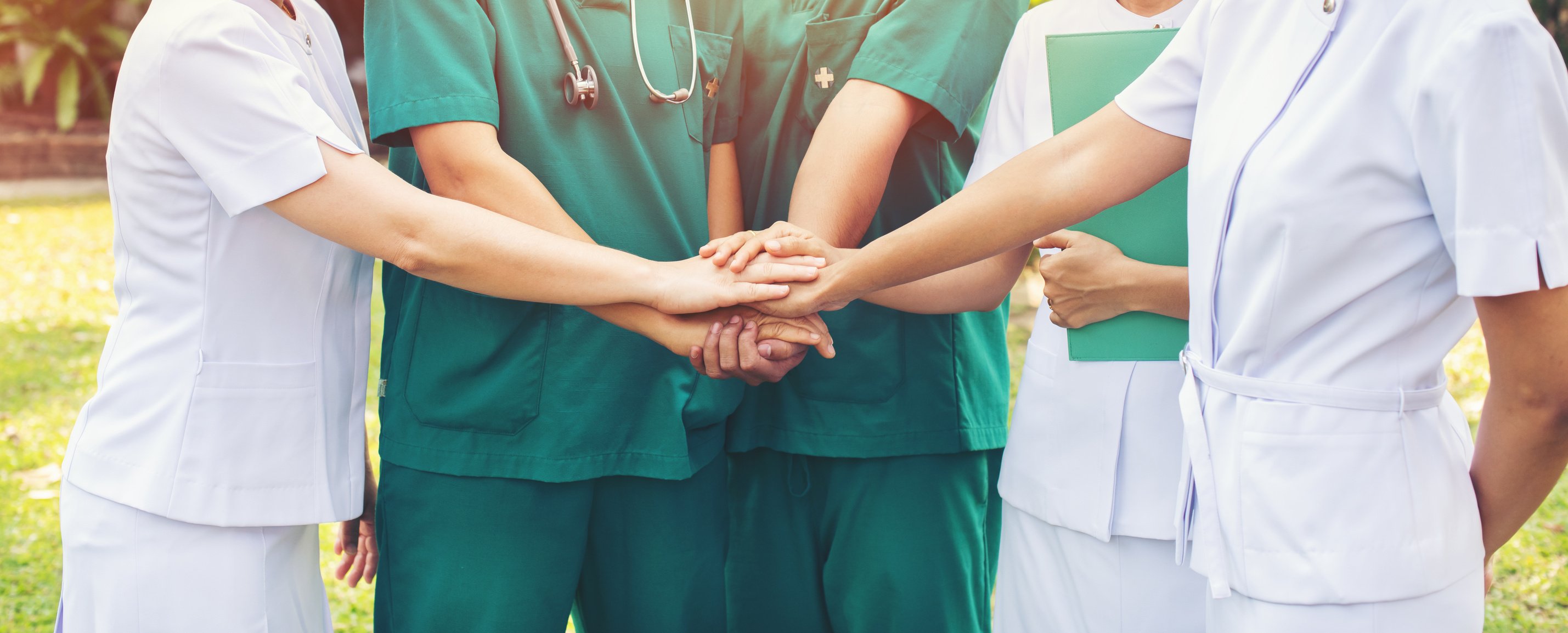 hands together between the doctor and nurses